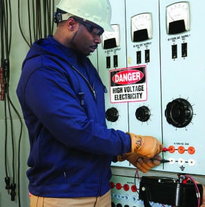 Actual electrician working on an industrial power distribution center.