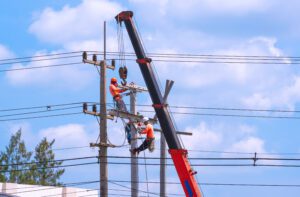 3-electricians-with-crane-truck-are-working-to-ins-2024-05-27-14-57-55-utc