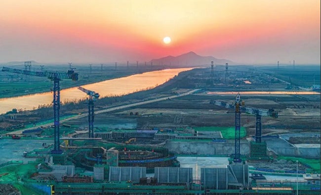 3. Construction is underway at the Xuwei Nuclear Heating and Power Plant in Lianyungang, Jiangsu Province. The project—which began concrete pouring for Unit 1’s nuclear island on Jan. 16, 2026—pairs two 1,208-MWe Hualong One pressurized water reactors with a 660-MW high-temperature gas-cooled reactor (HTGR) in the world’s first dual-coupling demonstration combining Generation III and Generation IV reactor technologies. Courtesy: China National Nuclear Corp. (CNNC)
