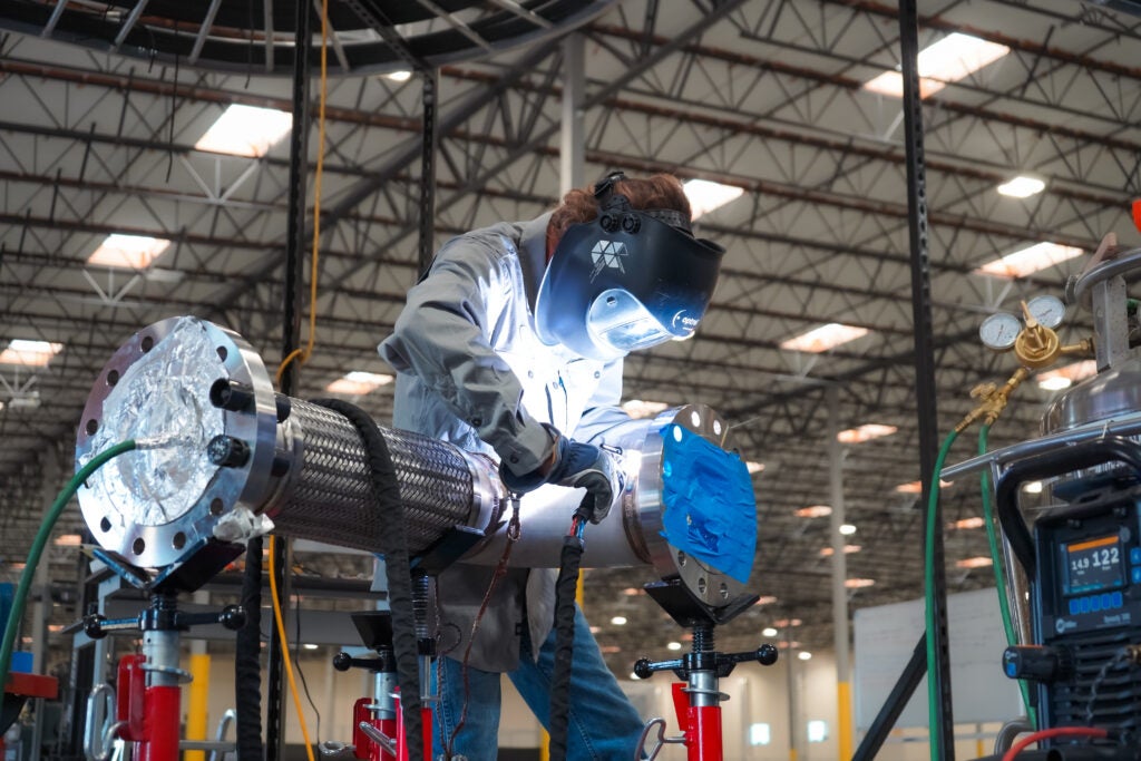 Antares lead technician Nate Jandra welds a power conversion system component in Torrance, California.