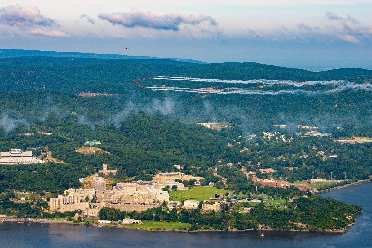 U.S. Air Force F-35A and F-22 demonstration aircraft and Royal Air Force Red Arrows fly over West Point.