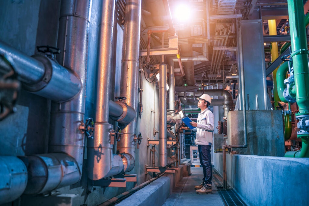 Octave - Engineer check status work at factory, Industrial zone steel pipelines and valves, engineer maintenance equipment at power plant.