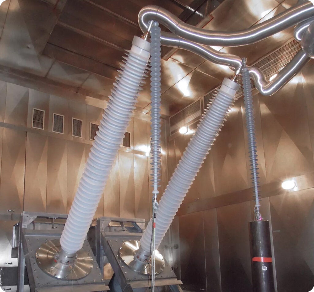 High-voltage bushings installed in electrical test equipment at a Trench Group facility.